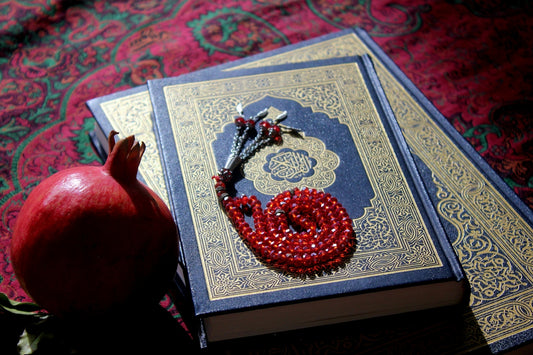 A book with a red beaded snake on top of it