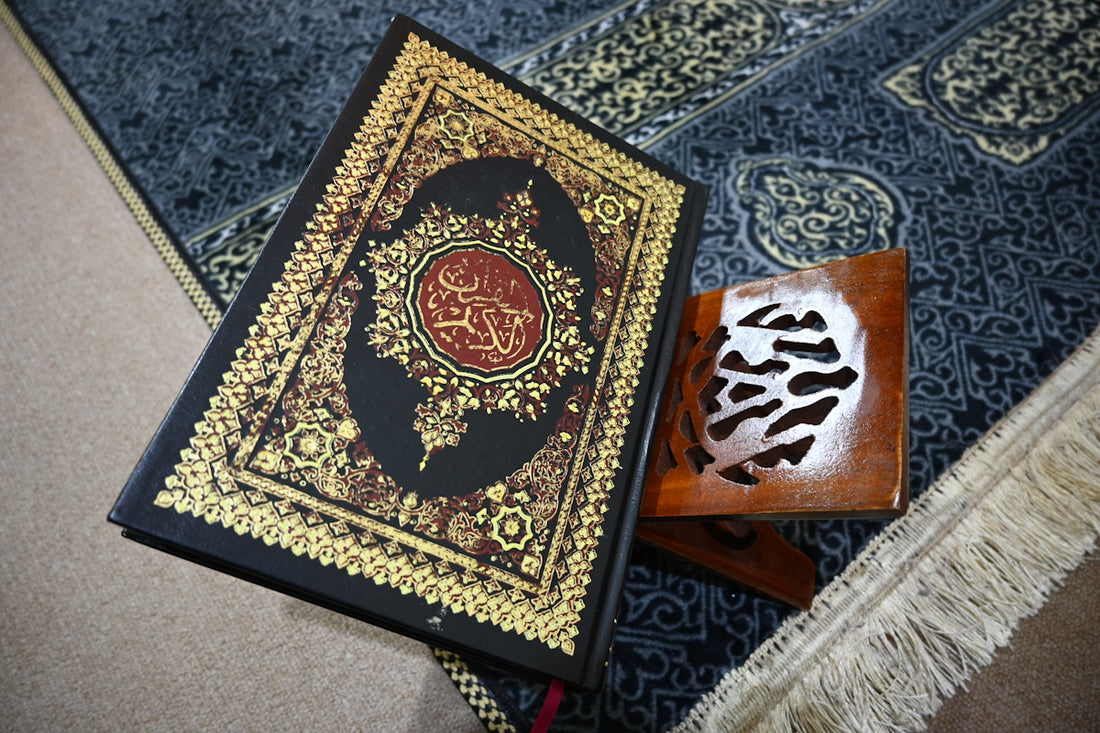 The quran rests on a prayer rug.